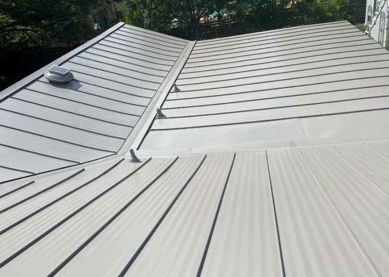 Solar attic fan installed on a metal roof for Roof Ventilation in Manville